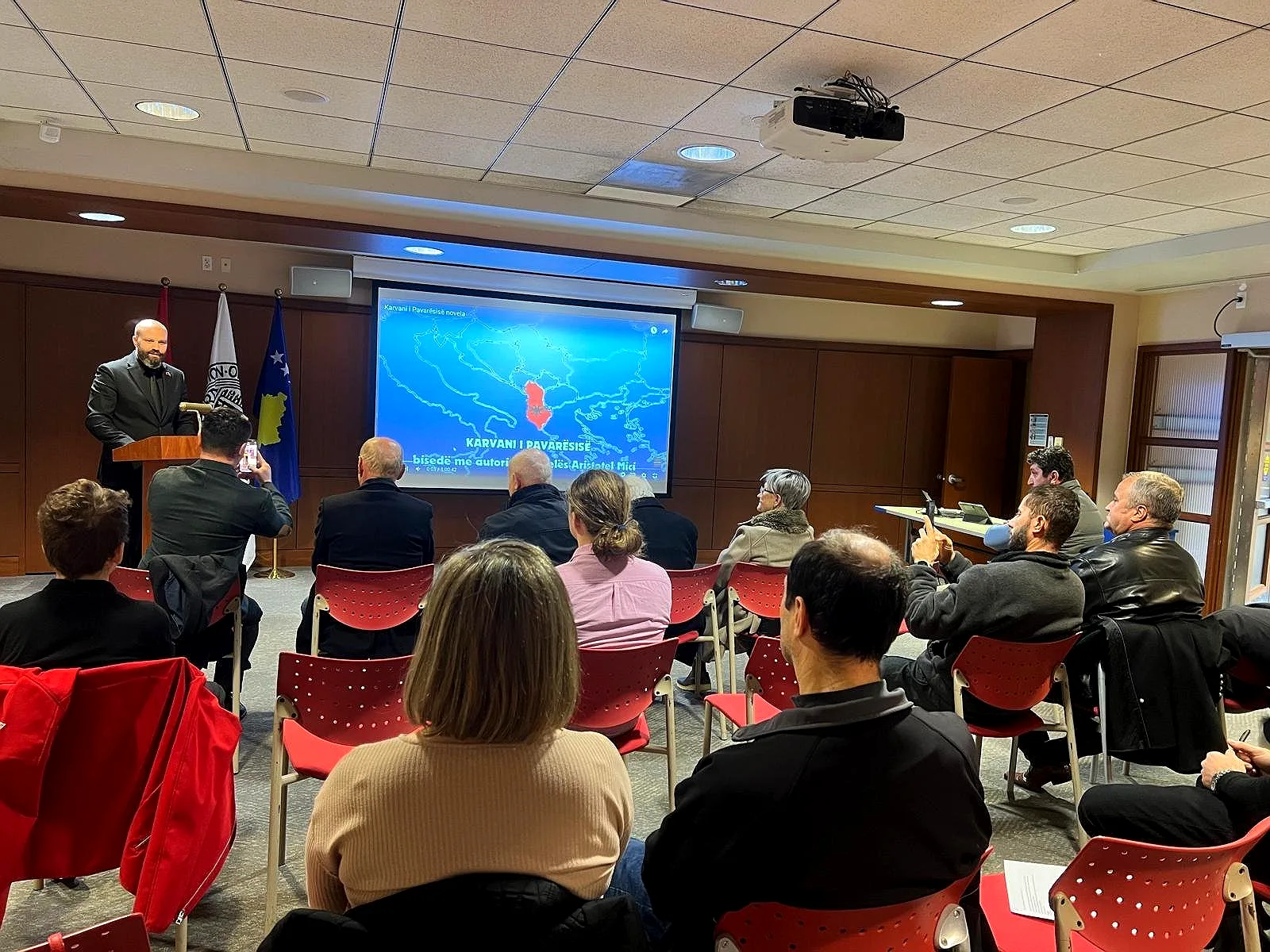 Vatra cultural presentation with Albanian and Kosovo flags
